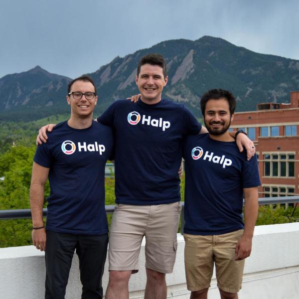 Pictured above, from left: Fletcher Richman with Halp co-founders Tristan Rubadeau and Komran Rashidov on a balcony in Boulder with the Flatirons in the background.