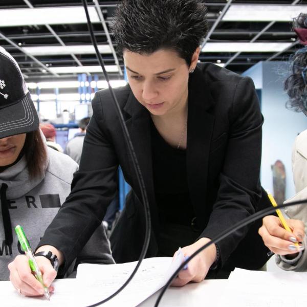 Dimitra Psychogiou works with two students in the ECEE circuits lab.