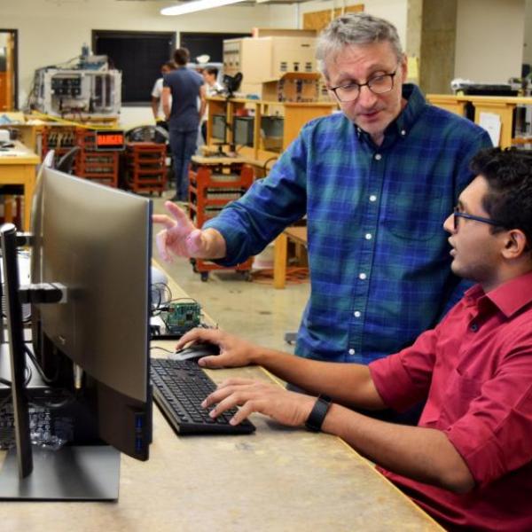 Dragan Maksimovic working with a student in the CoPEC lab