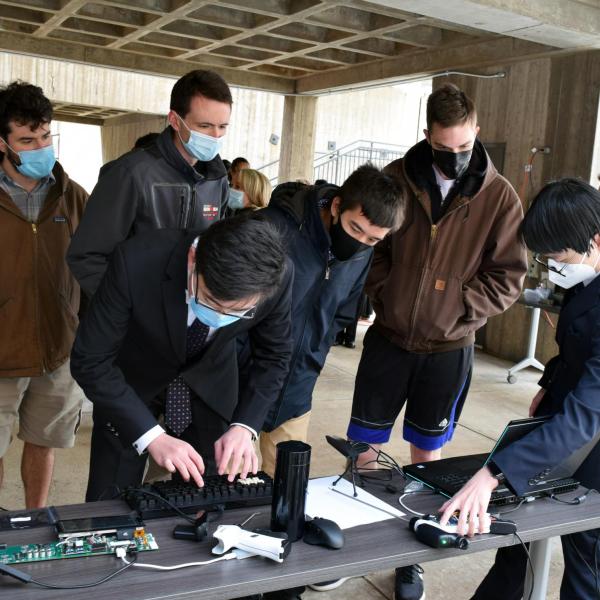 Members of the Cutting Edge team demonstrate their device for expo visitors.