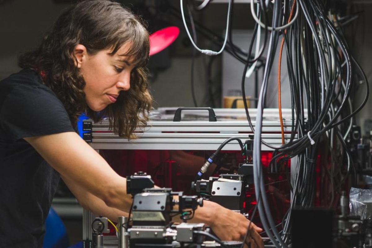 Graduate student working with equipment