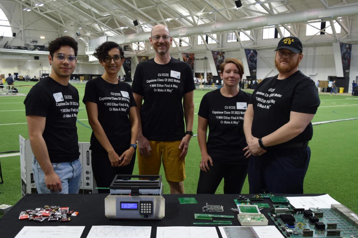 A team poses for a photo at the Engineering Projects Expo in the Indoor Practice Field