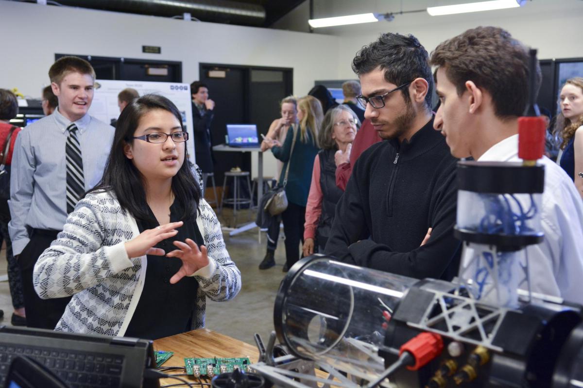 A student explains her project to visitors at the 2017 ECEE senior design expo.
