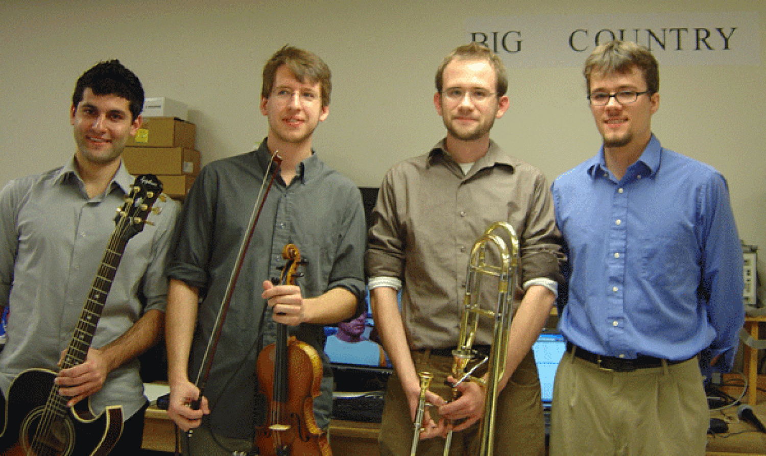 The four members of Big Country holding musical instruments