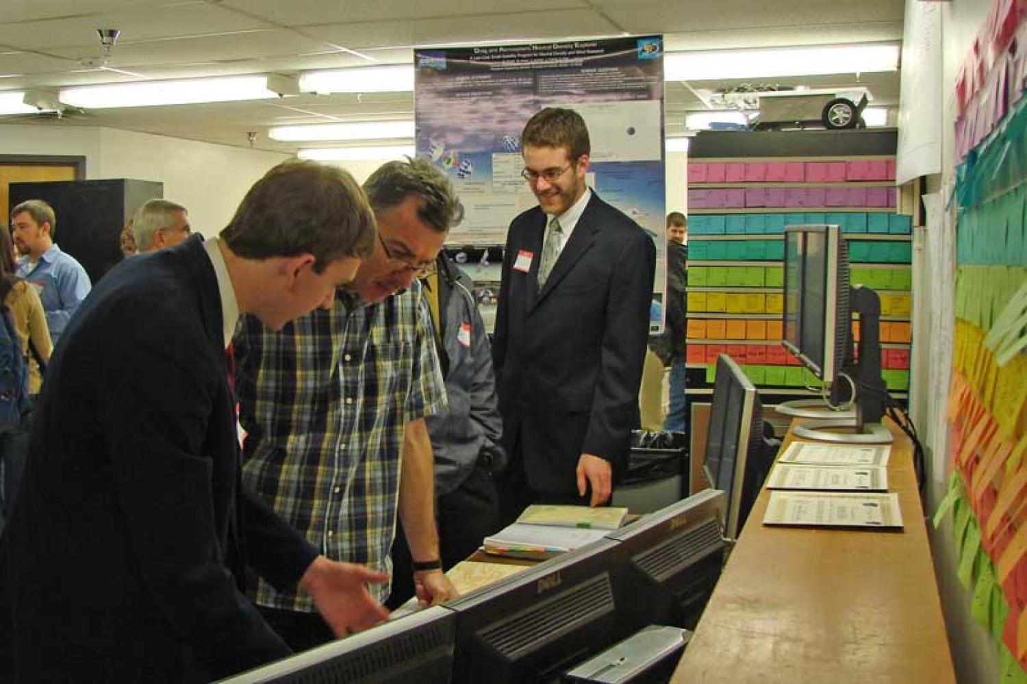 A DANDE team member demonstrates their project to a faculty member during the capstone expo.