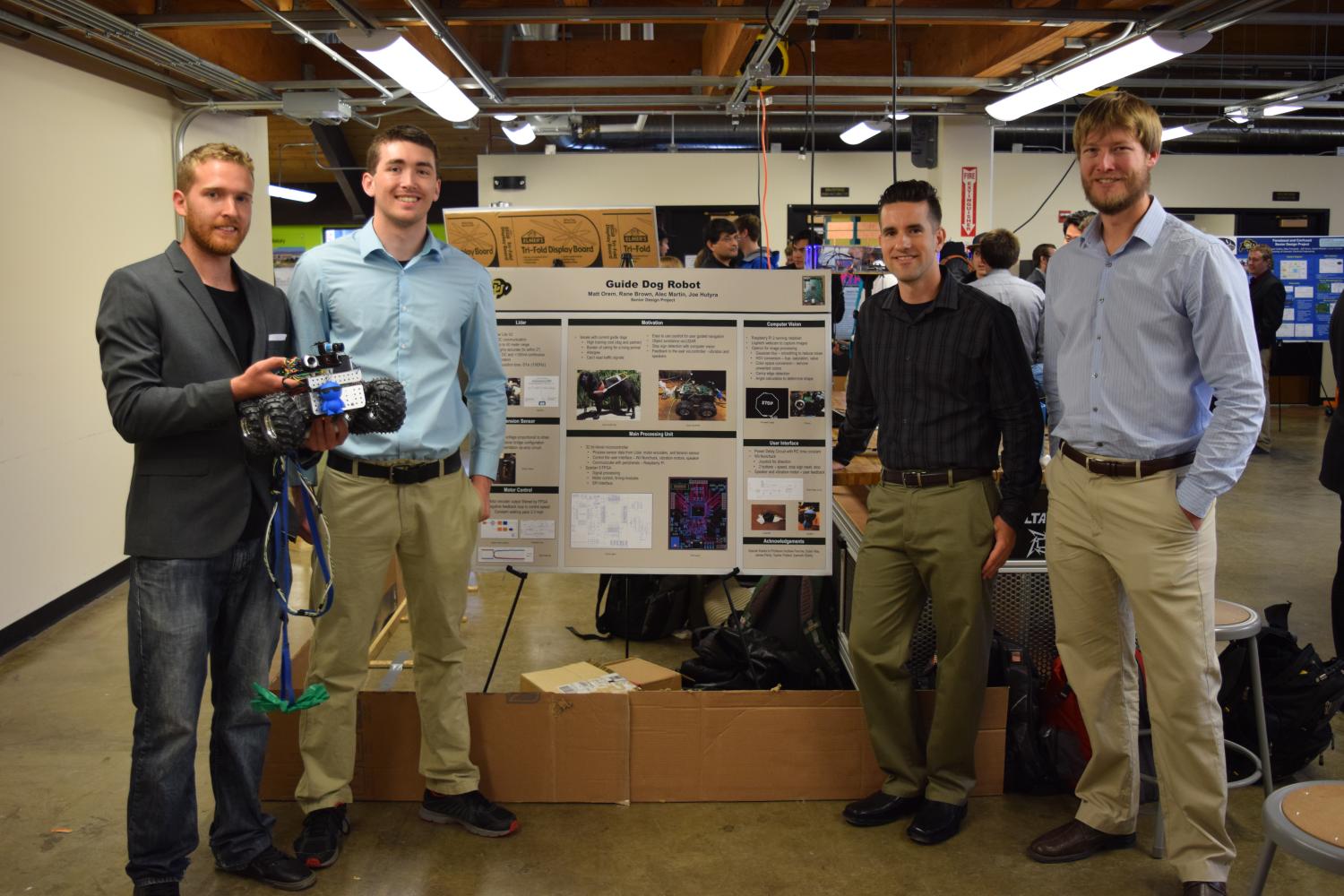 The members of Voltallica with their prototype and demonstration track at the capstone expo.