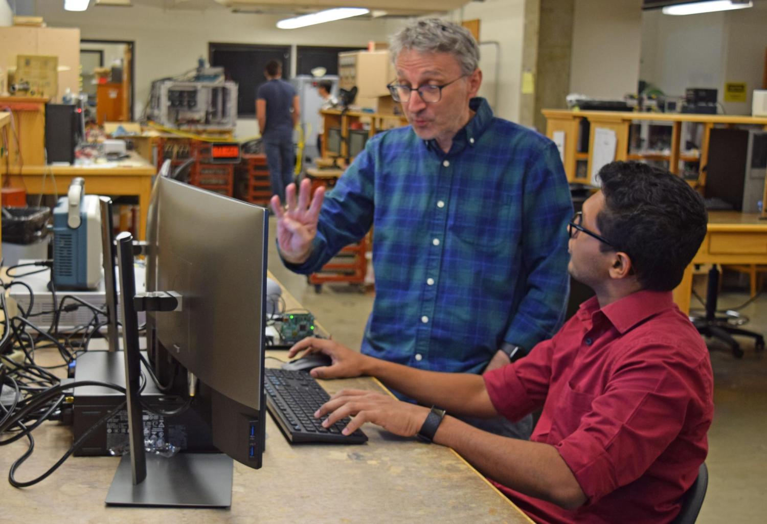 Maksimovic discusses a project with a graduate student in the power electronics lab