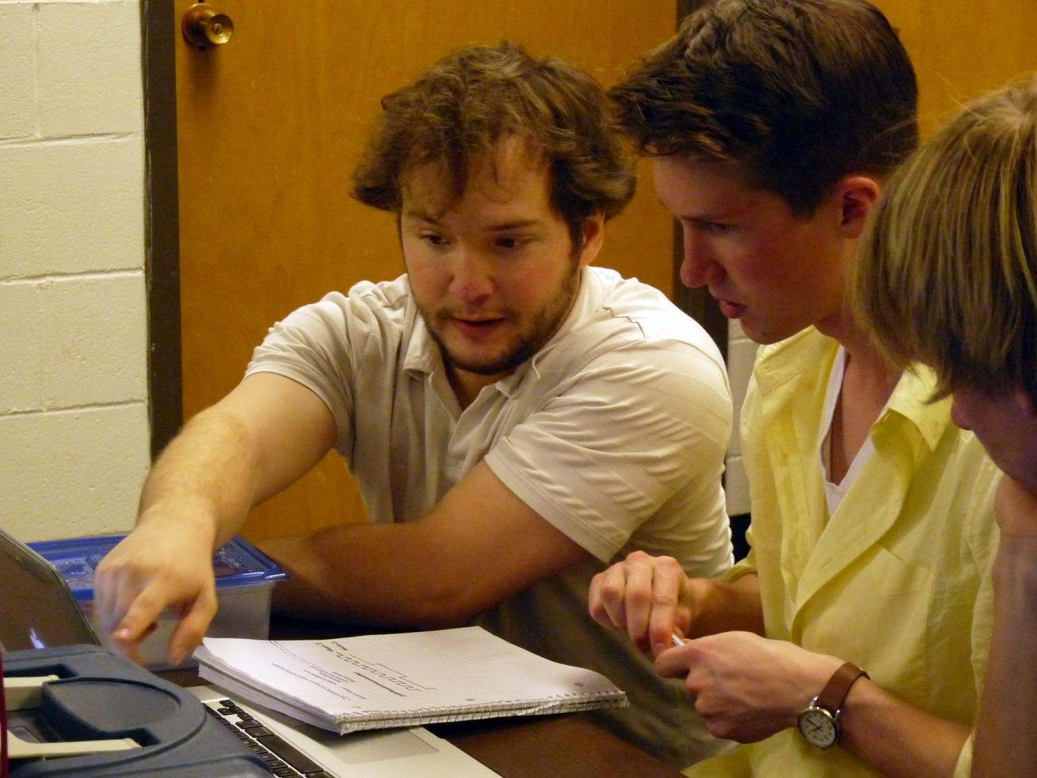 Alex Mault helps students in lab