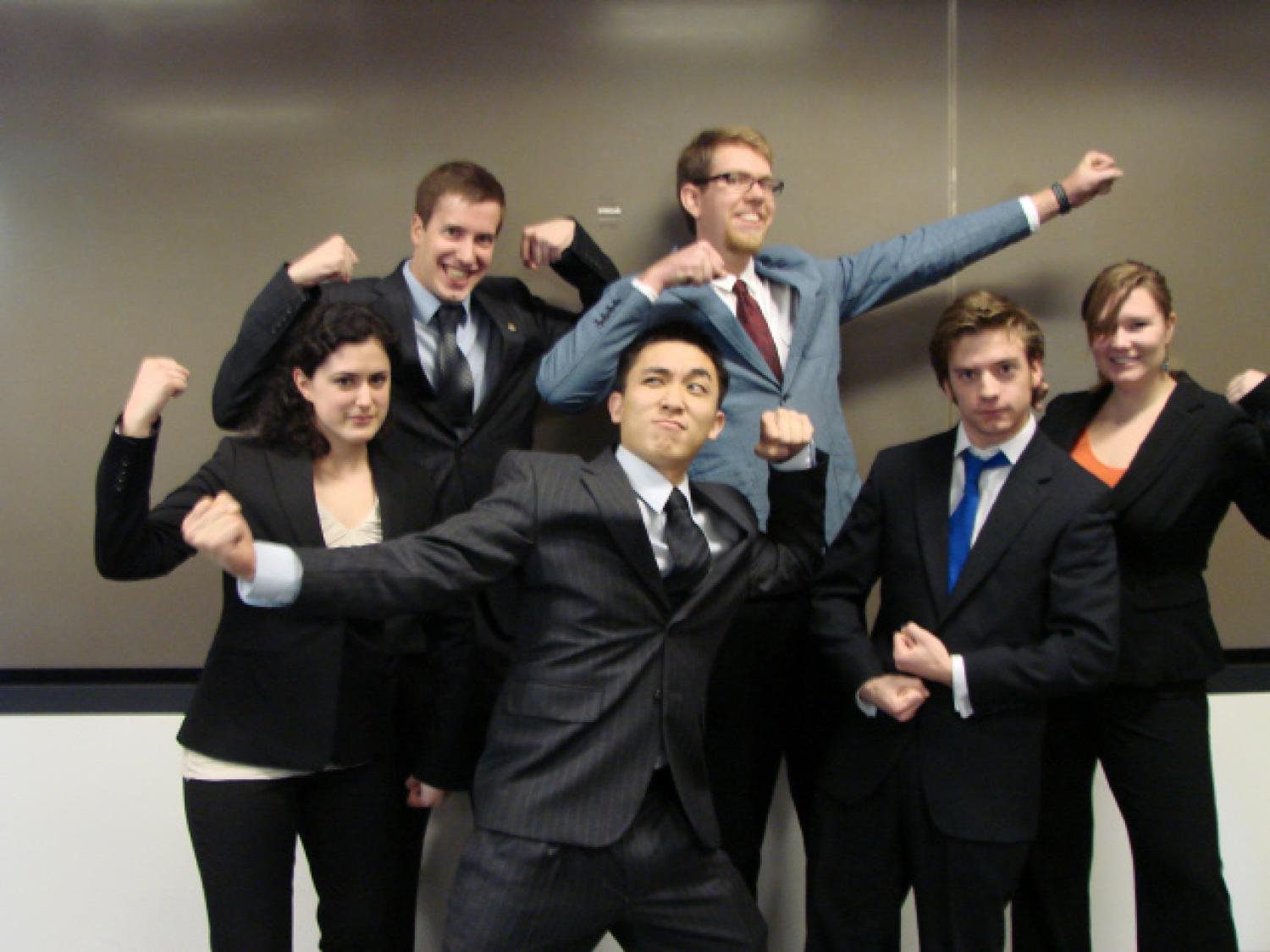 The six members of Myoelectric pose like superheroes