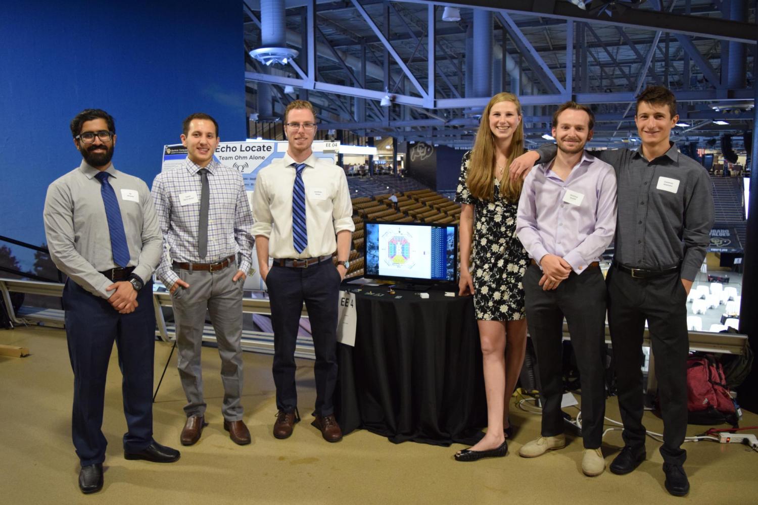 The team with their display at the 2018 engineering expo.