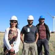 Researchers at the NREL Flatirons Campus, posing in front of the two-bladed SUMR-D in the background. 