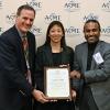 Pao receives her plaque from two colleagues during the ASME conference. 