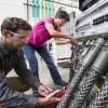 NREL researchers work on the Consolidated Utility Base Energy System (Photo credit: Dennis Schroeder, NREL)