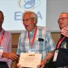 Barnes receives an award on stage at BIOEM 2019