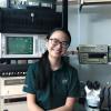 Giselle Koo sits in a lab filled with RF equipment
