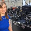 Juliet Gopinath sits by an optical table in her lab.