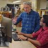 Maksimovic discusses a project with a graduate student in the power electronics lab