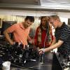 Gopinath (center) works with two grad students at an optics table