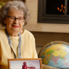 Irene Peden holds a photo from her Antarctic trip