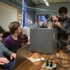 Three students troubleshoot their safecracking robot in the BTU Lab