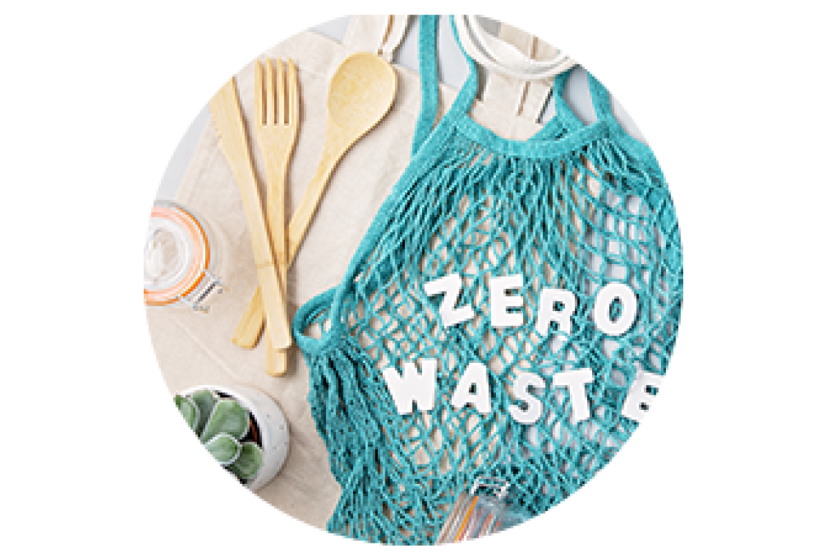 A resuable bag that says Zero Waste with other sustainable items surrounding