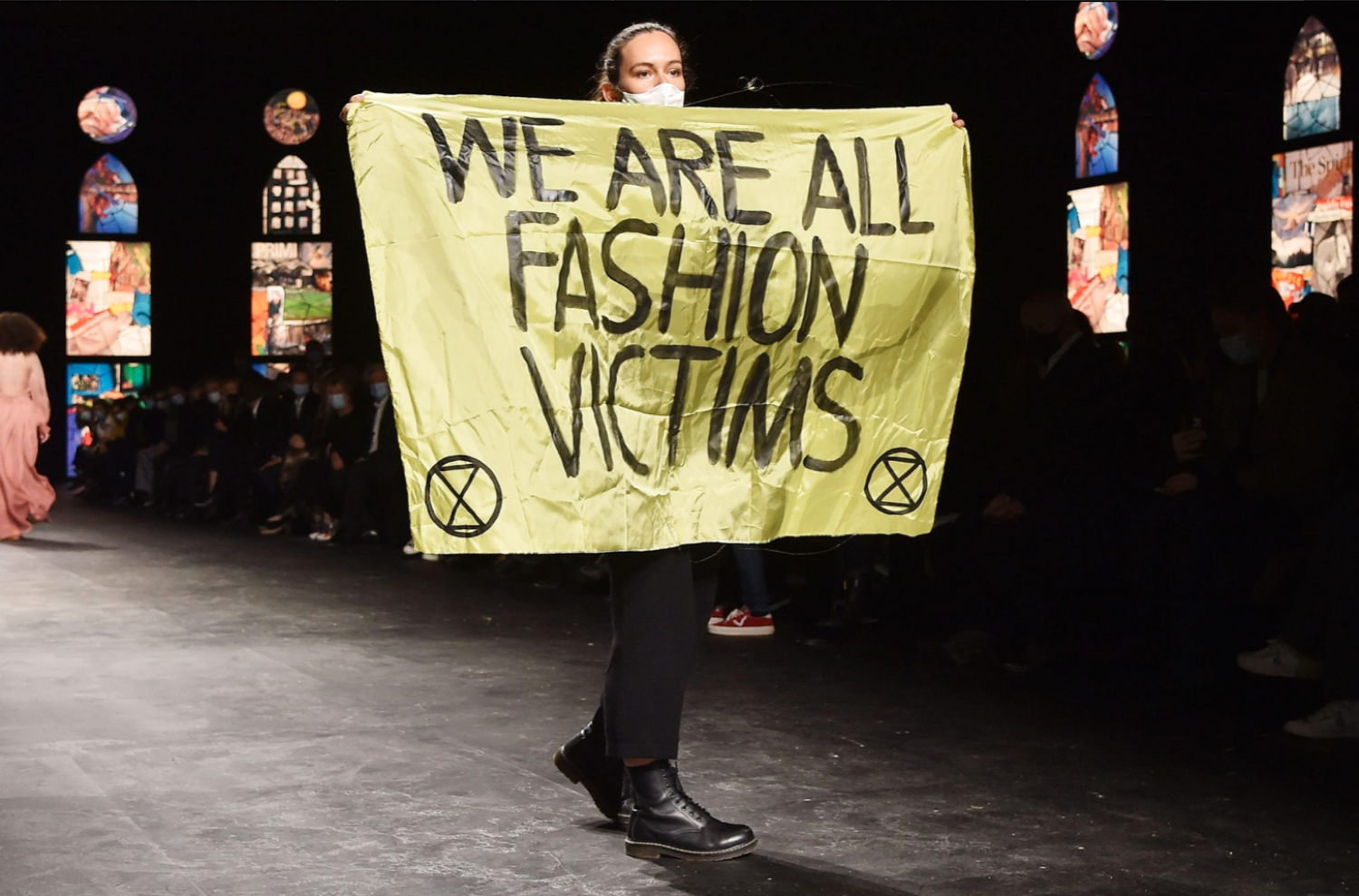 Protester with climate change banner crashes Louis Vuitton show
