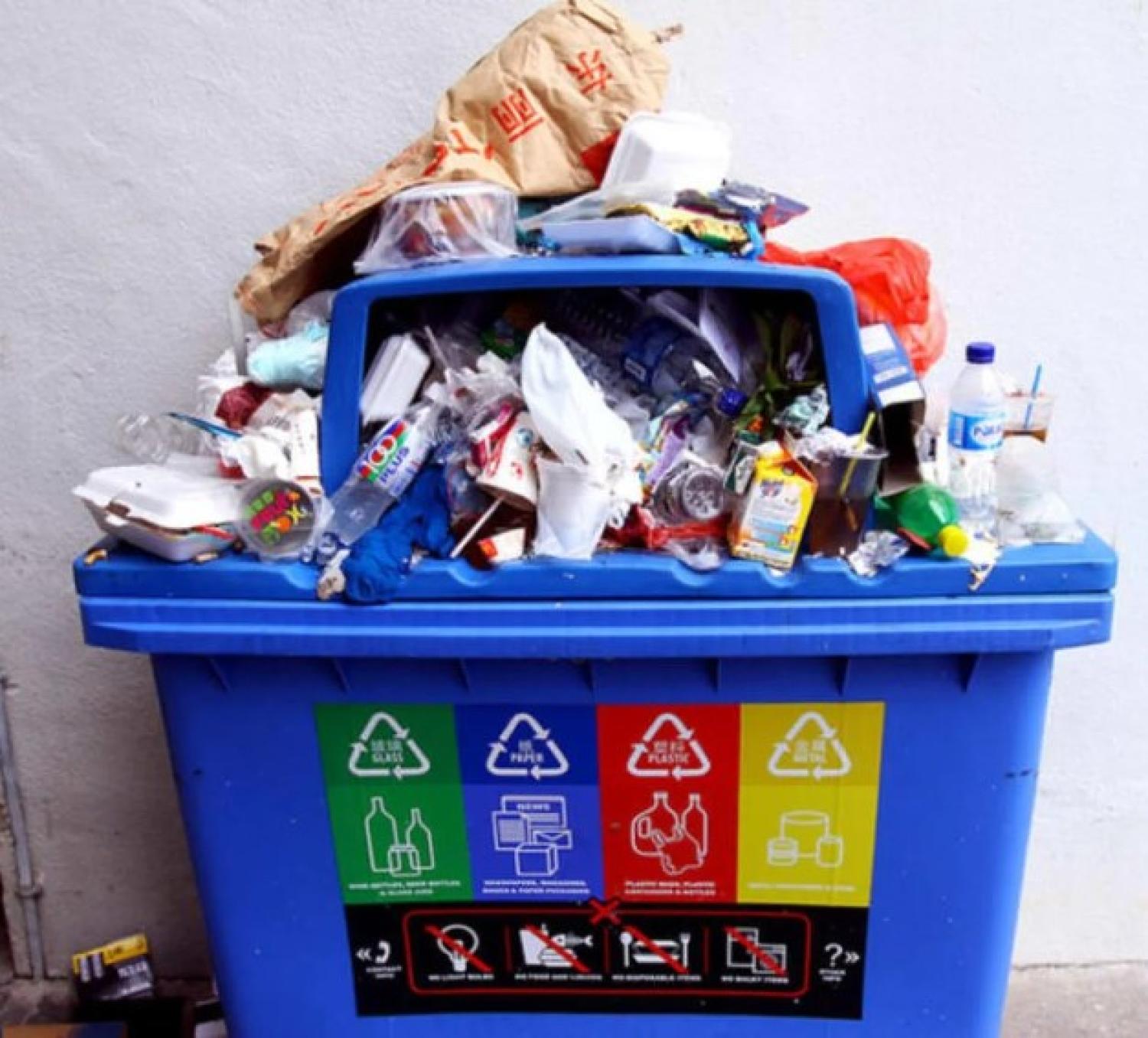 recycling bin overflowing with trash