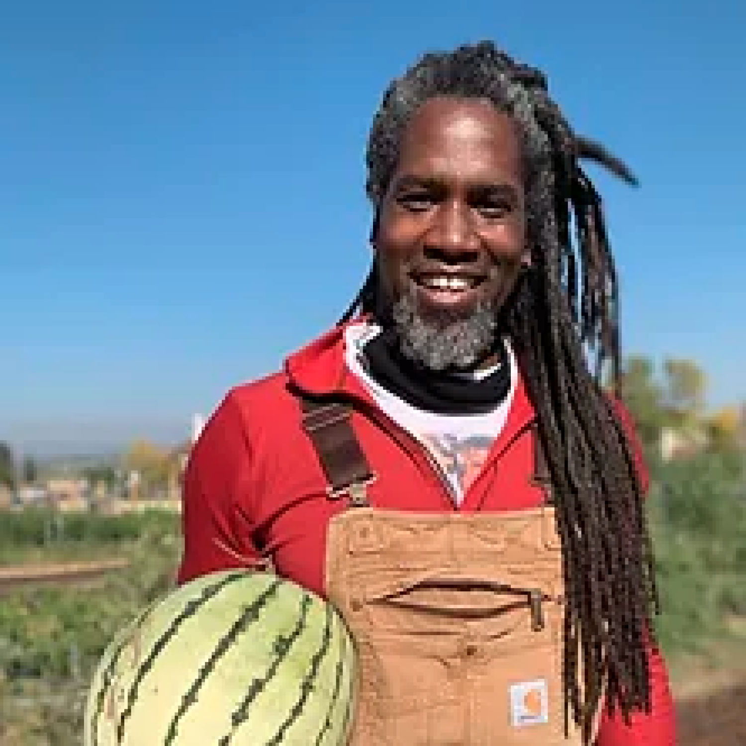 Damien Thompson in field holding produce