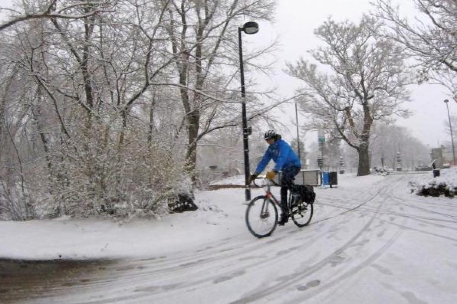 student biking in snow