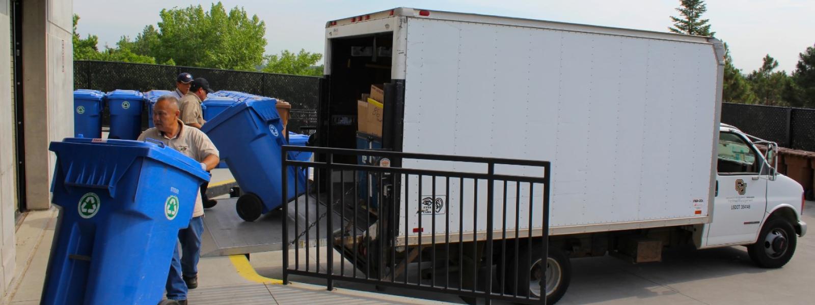Facilities Management Crews unload full Recycling Poly-Carts
