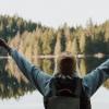hiker in front of lake