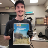Subway employee showing the “Zero Foodprint Member” poster at their storefront