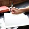 student writing in notebook