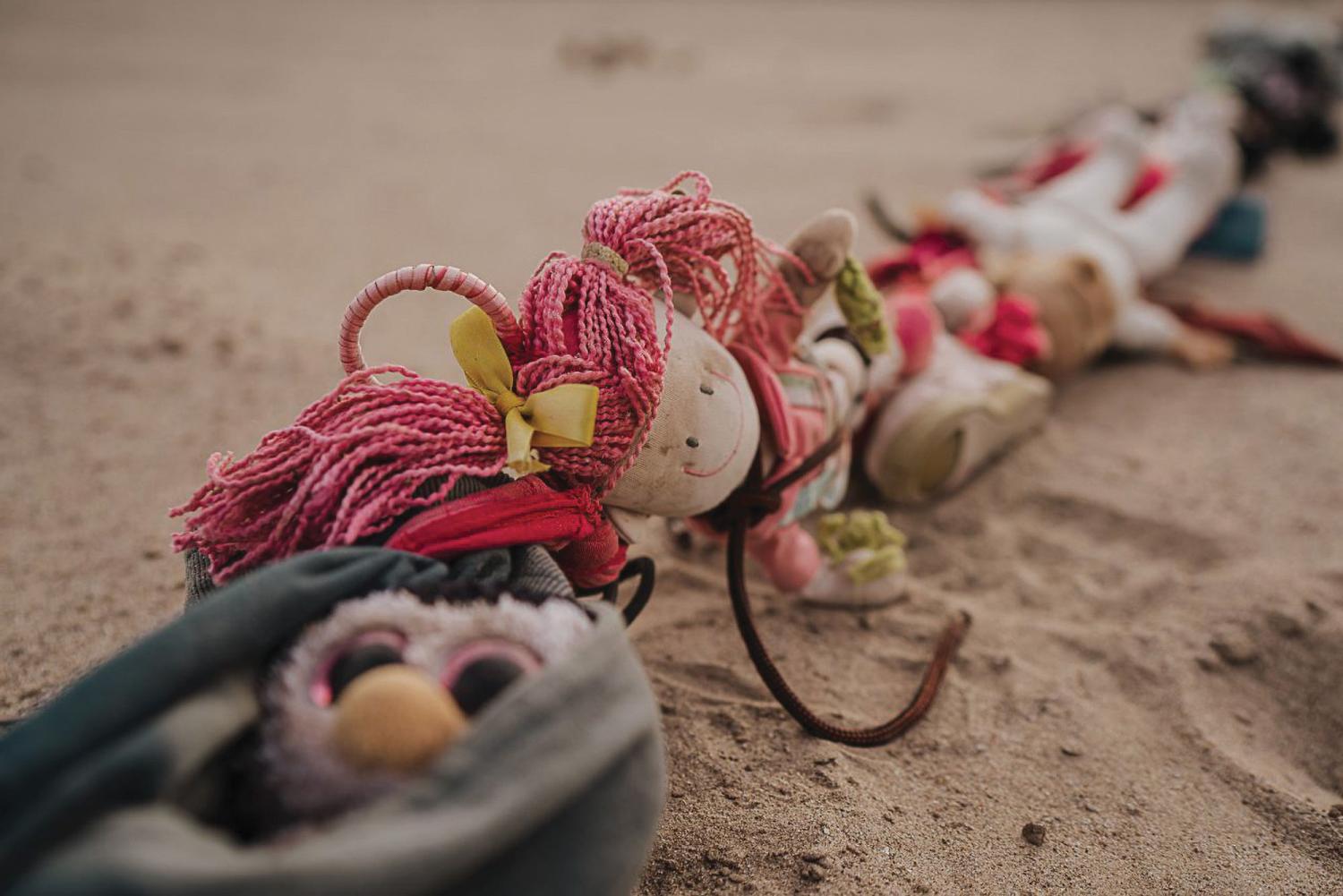 Photograph of toys tied together that are relative to the content of the article "What Remains"