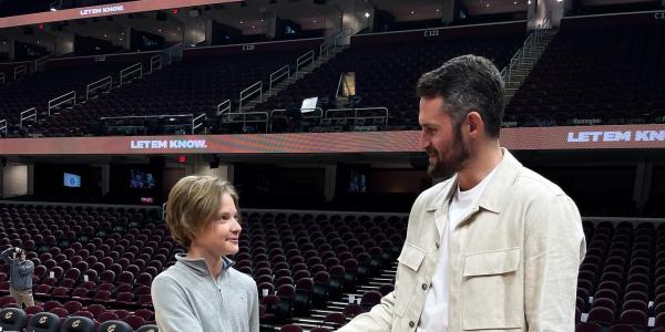 Kevin Love with a fan at a basketball game