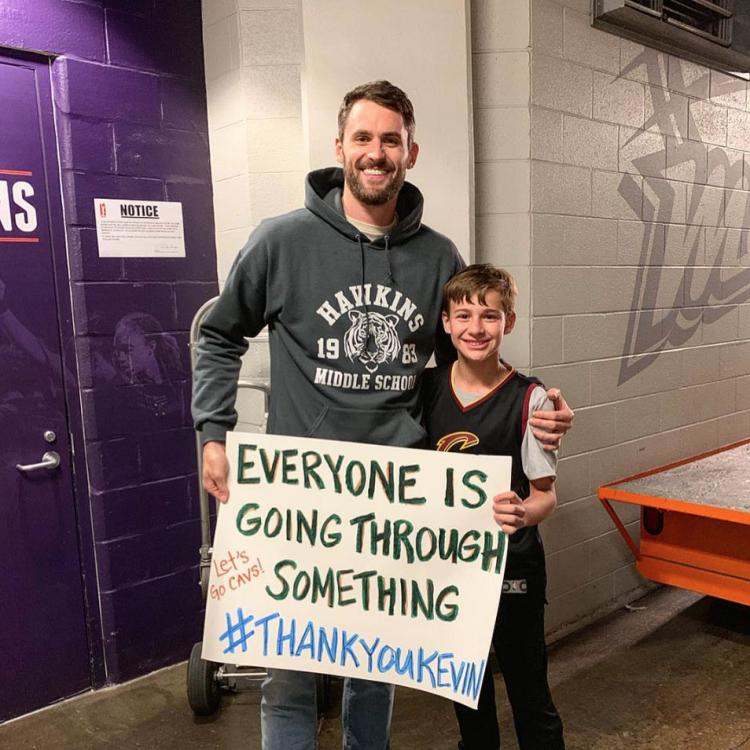 Kevin Love with a fan at a basketball game