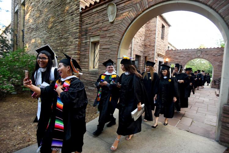 Graduates walking to commencement