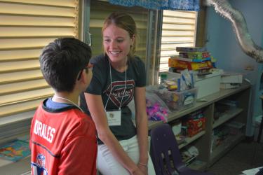 Teacher with Student at Literacy and Media Lab