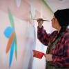 Danielle SeeWalker painting in the School of Education