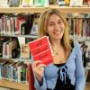 Photograph of Cassidy Ktsanes holding the book "All About Love"