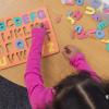 Girl with alphabet toy