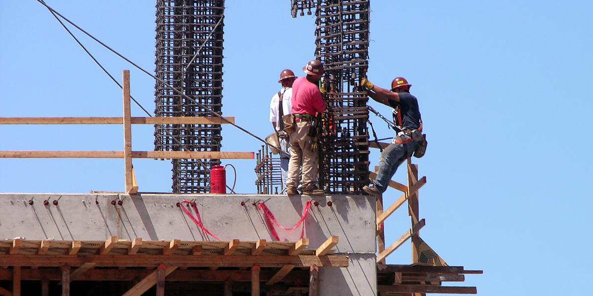 Construction workers high up on a building