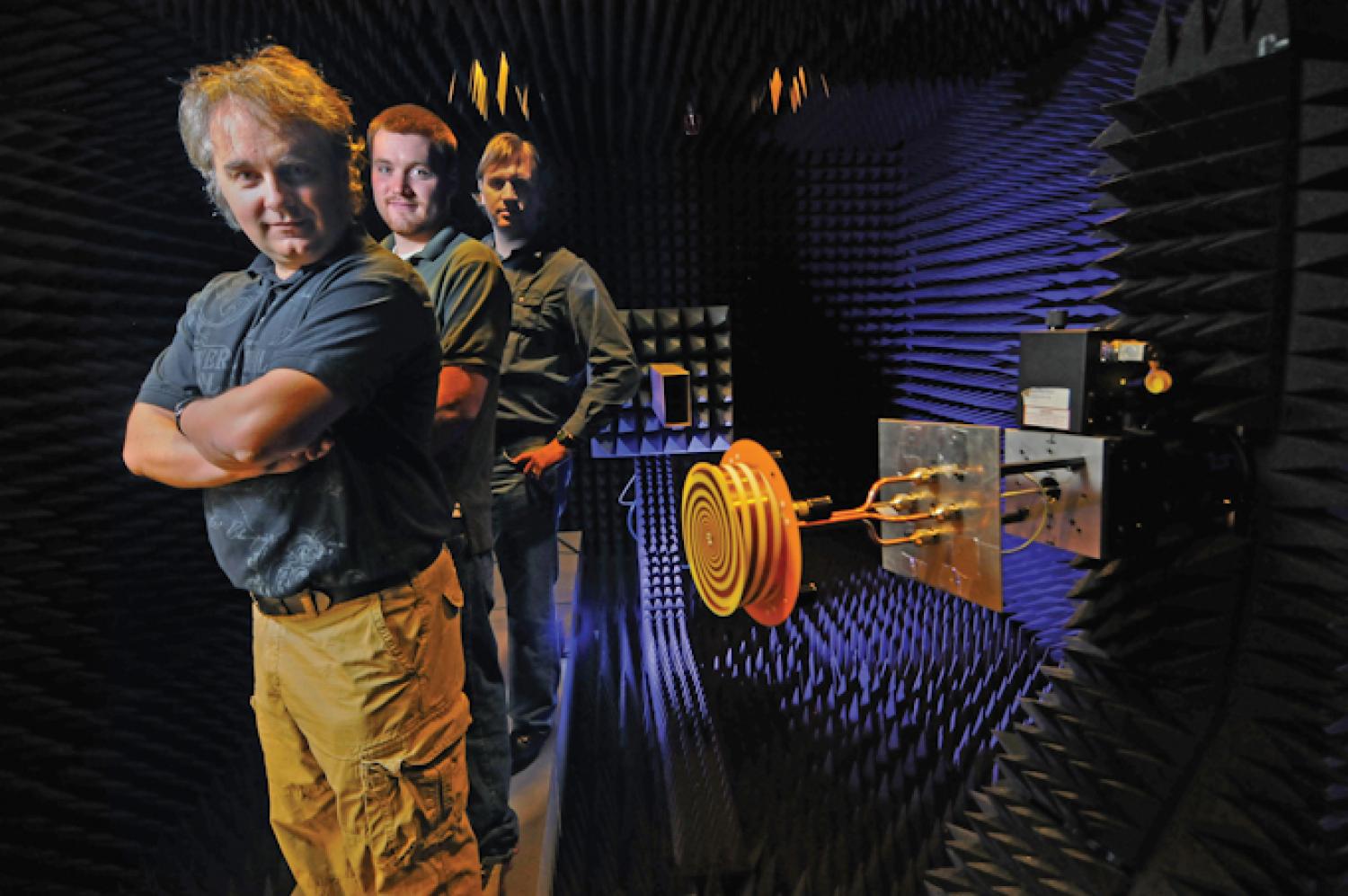 Dejan Filipovic and his students pose inside an antenna test chamber