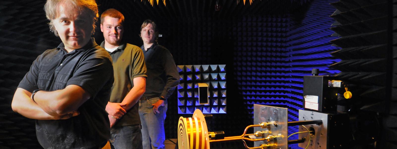 Dejan Filipovic and two of his grad students pose in their antenna test chamber