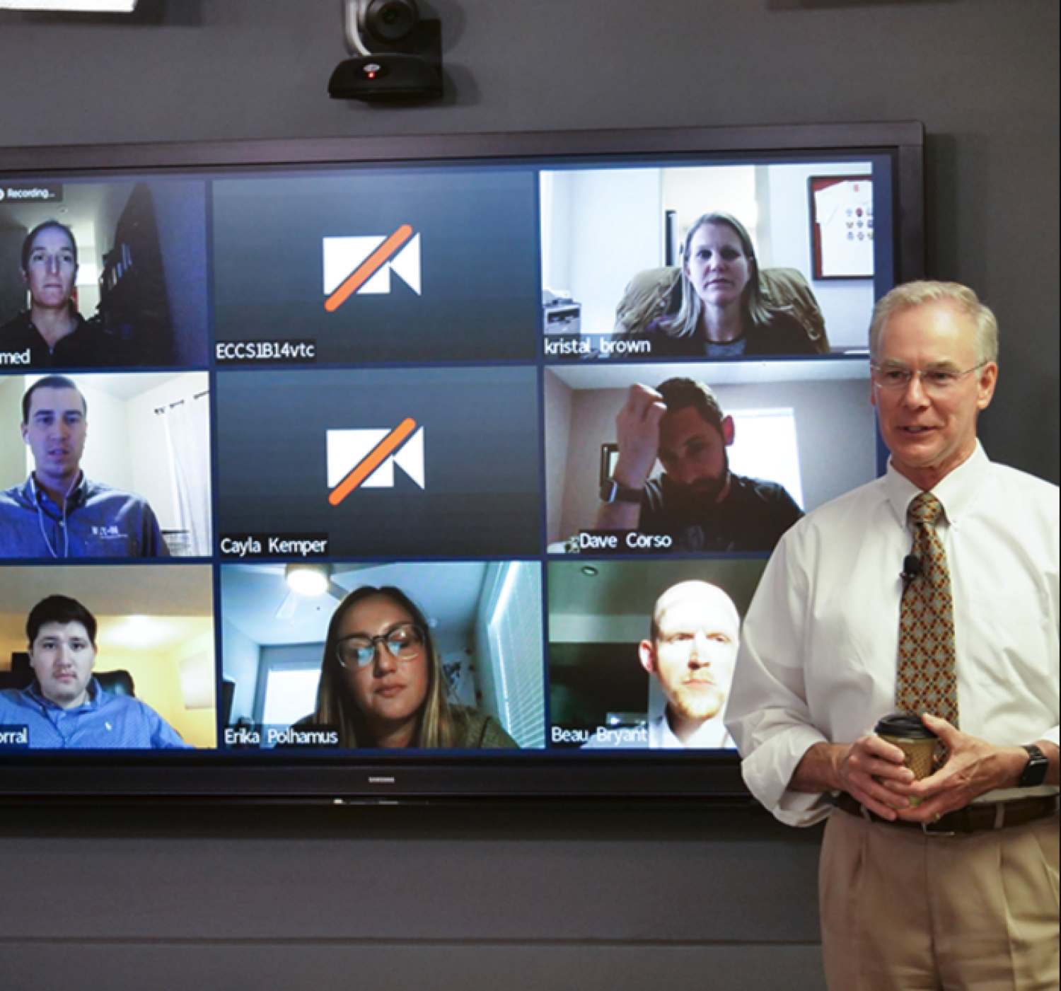 Professor Moorer in front of screen with distance students