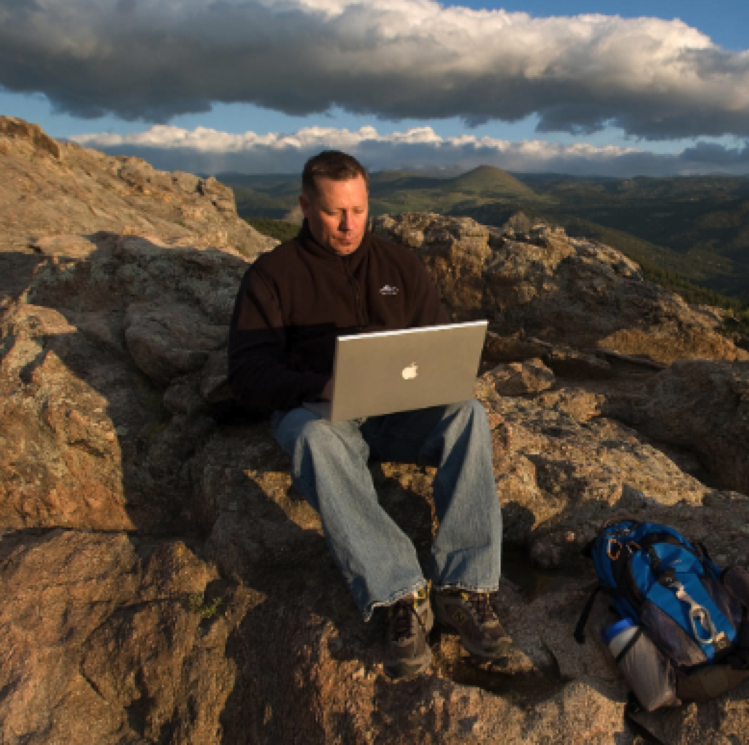 Brian Ellwanger studies on a computer at the Lost Gulch Overlook above Boulder Canyon.