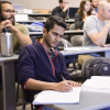 male student in blue shirt studying in class