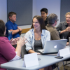 Two female students talking in class