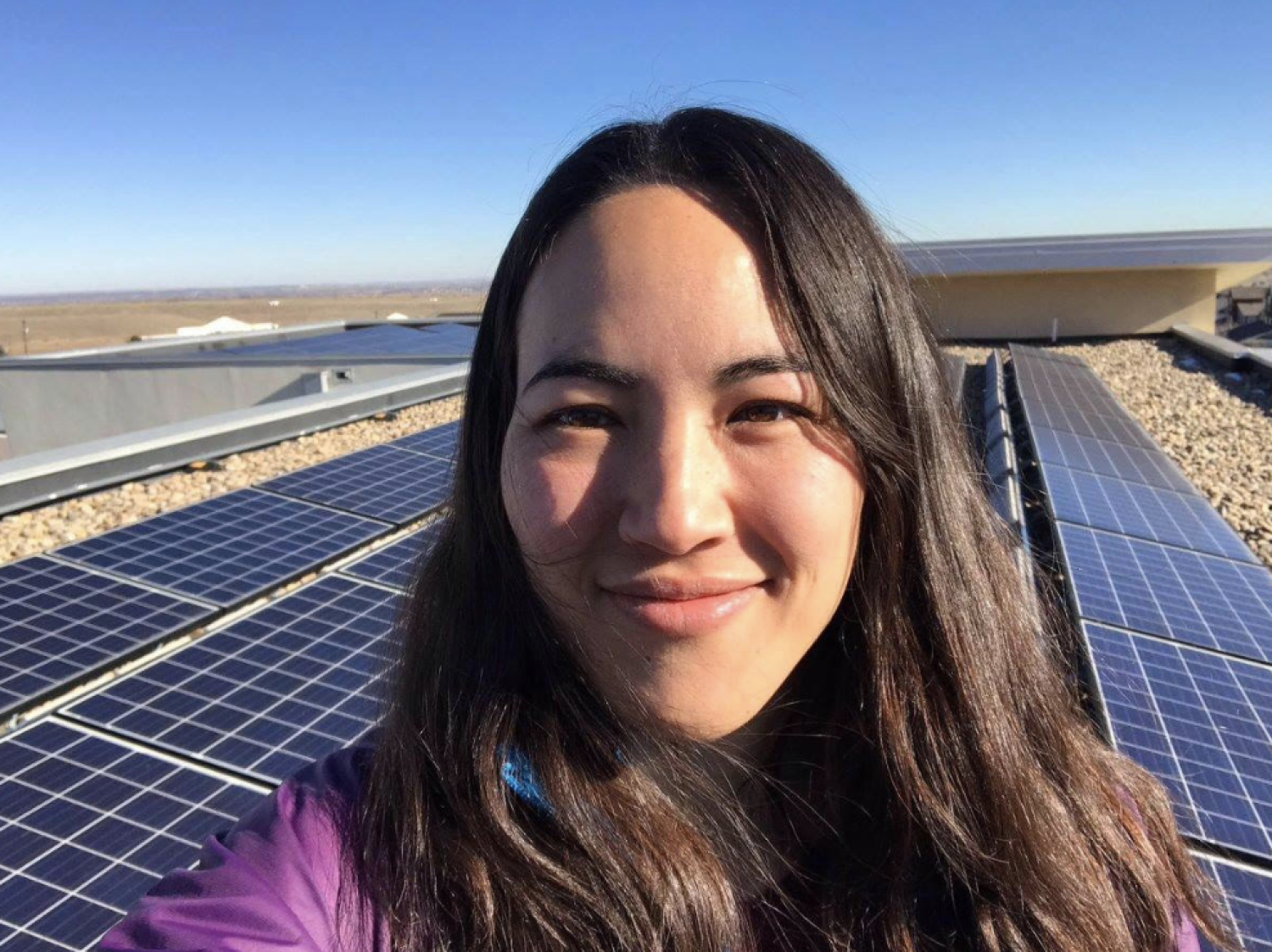 Kyri Baker selfie in front of solar panels