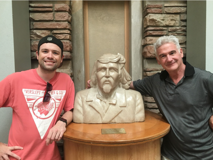 Rory Lynch and his father both standing near the statue